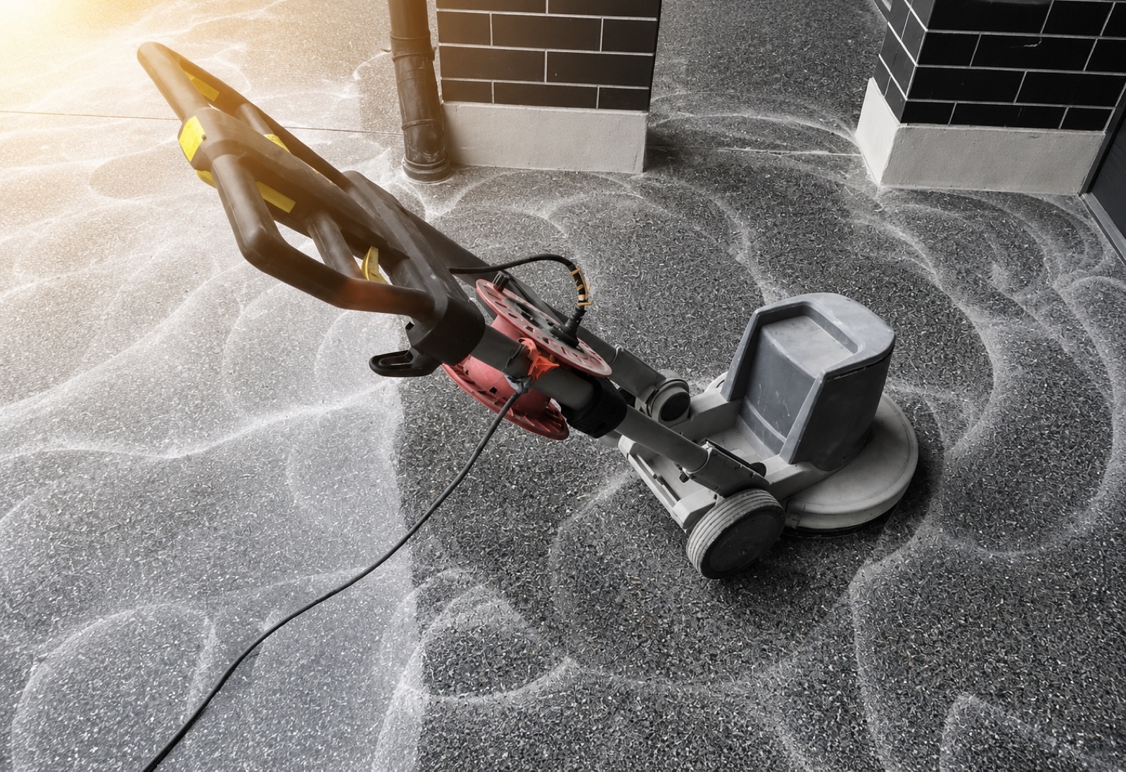 Diamond grinding machine preparing a concrete floor for epoxy coating in Grand Forks