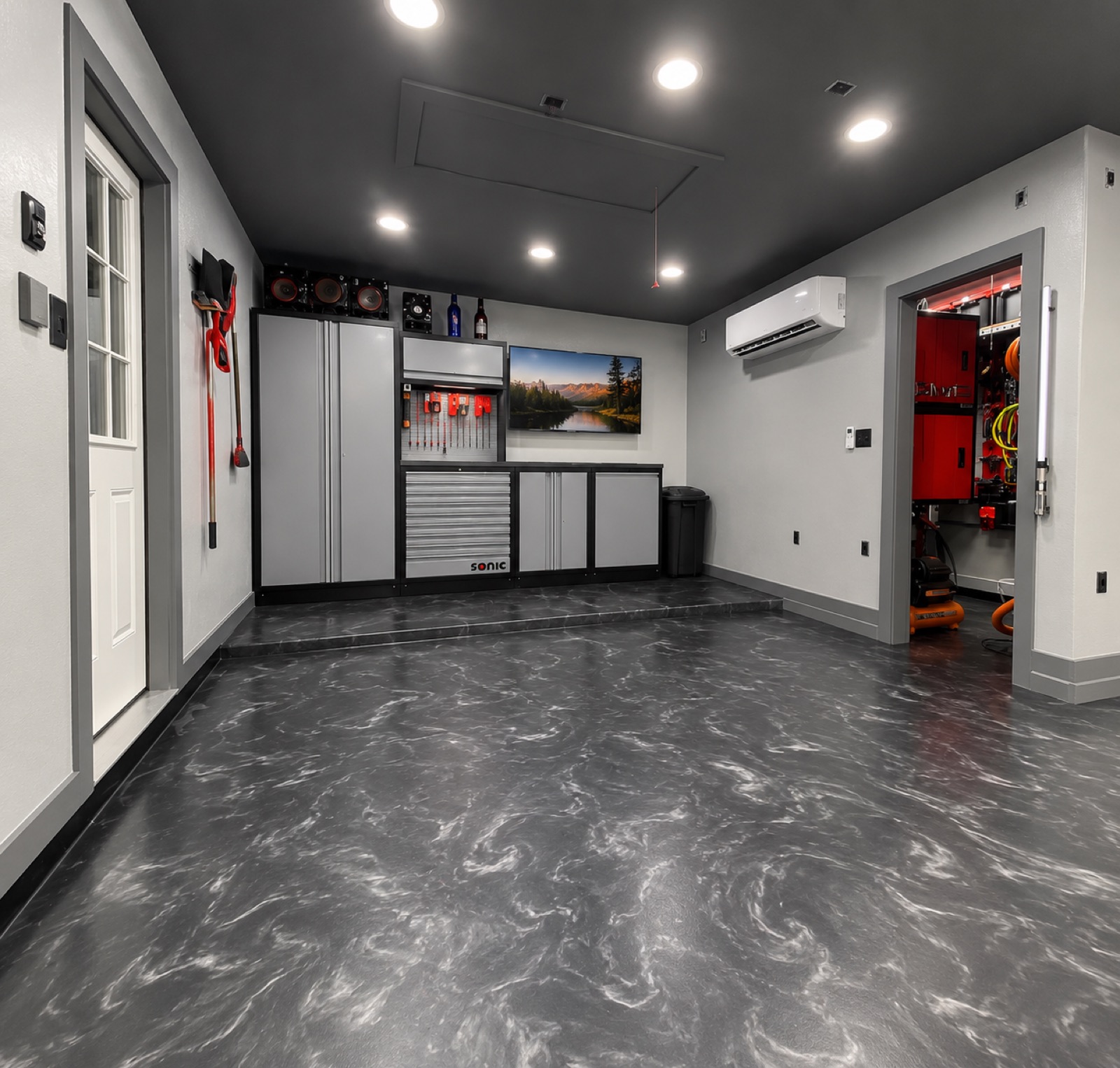 Dark marbled epoxy garage floor with built-in storage cabinets in a Grand Forks, ND home